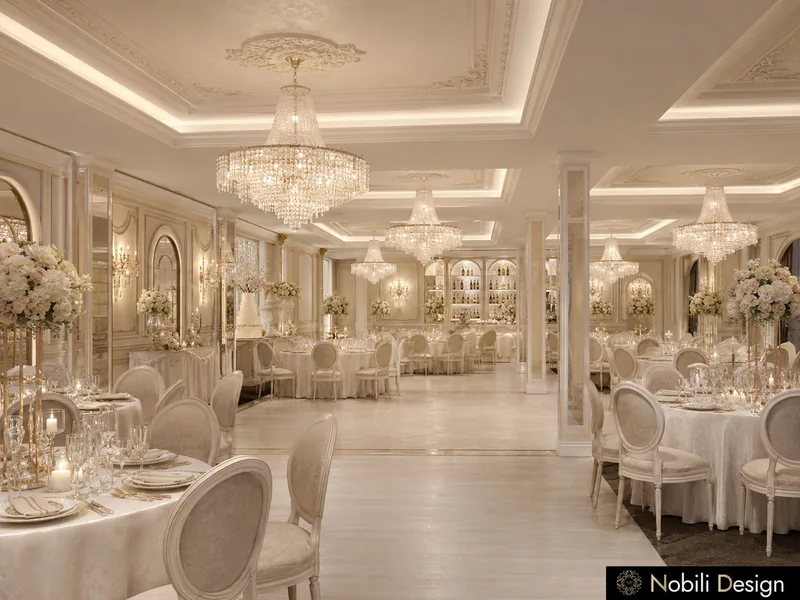 Ballroom interior design of dressed tables with gold-rimmed glassware and white roses under a crystal chandelier