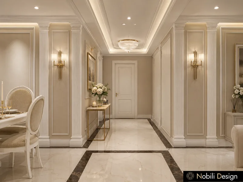 Classic entrance hall with fluted pilasters, gold wall sconces and a marble floor with dark borders