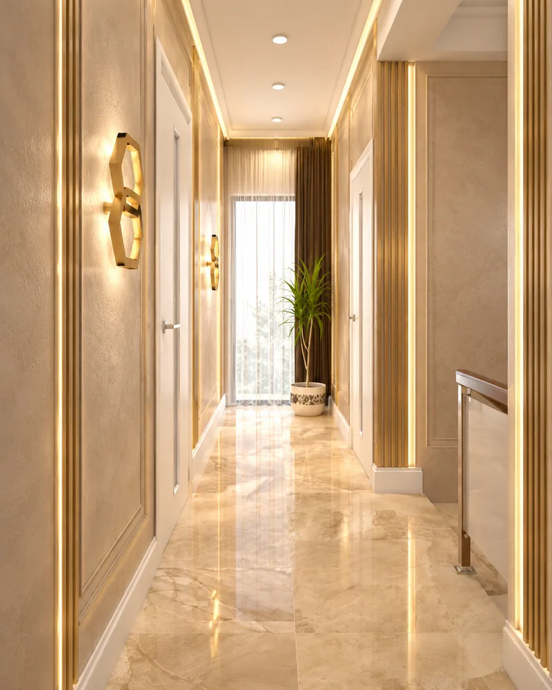 Upper hall with polished stone floor, brass hexagon sconces, fluted gold pilasters and a window at the end