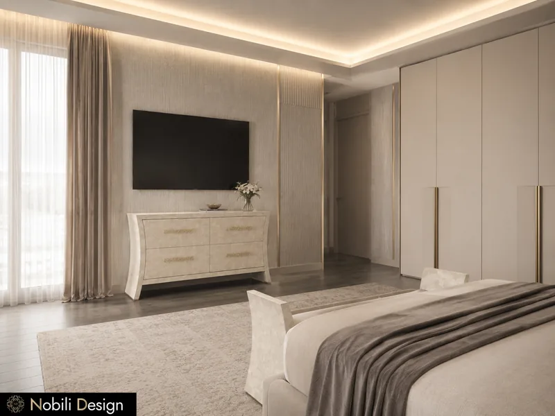 Suite d'hôtel avec commode ivoire sous un mur TV, armoire à poignées en laiton et banc au pied du lit