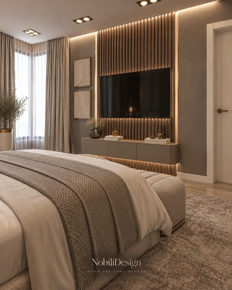Guest bedroom TV wall with backlit fluted walnut slats, floating taupe console, linen curtains and textured rug