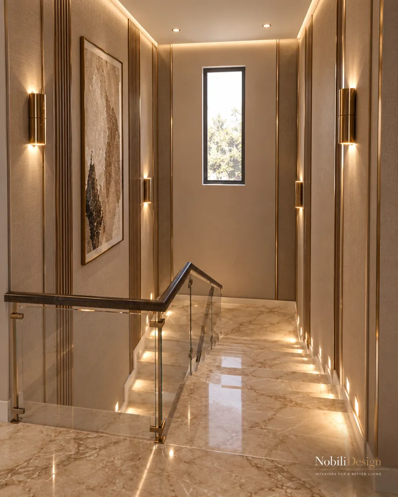 Upper landing with glass balustrade, walnut handrail, marble stairs with LED step lights and bronze sconces