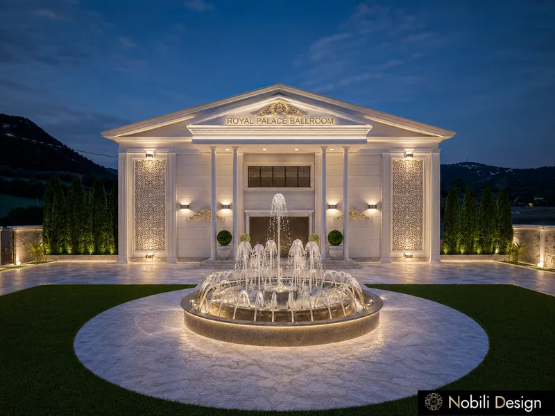 Event venue forecourt with lit circular fountain on stone paving in front of a neoclassical columned facade