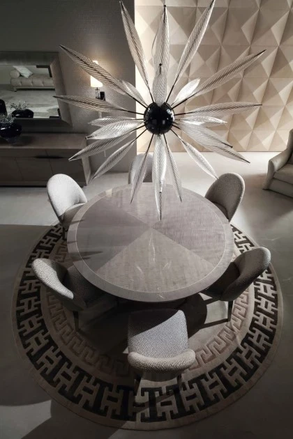 Elegant round side table with a distinctive base design suitable for refined contemporary living interiors.