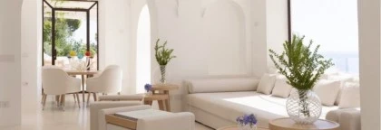 PAOLINO pouf and tray, ANACAPRI dining chair, FABRIZIO dining table, FARAGLIONI sofa