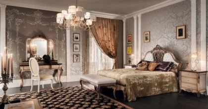 Letto di lusso collezione Granguardia Francesco Pasi con struttura in legno massello noce intagliato e testata capitonn in pelle bianca per camera classica